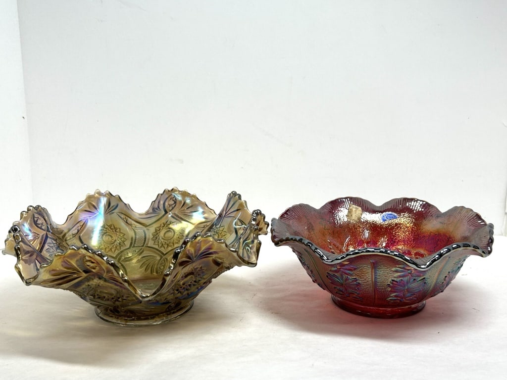 IMPERIAL GLASS TWO CARNIVAL GLASS BOWLS 20TH CENTURY: Lot of two iridescent pressed glass bowls produced by the Imperial Glass Company in the Star and File and Lustre Rose patterns. Both pieces feature an embossed IG mark on the base, and the red bowl re