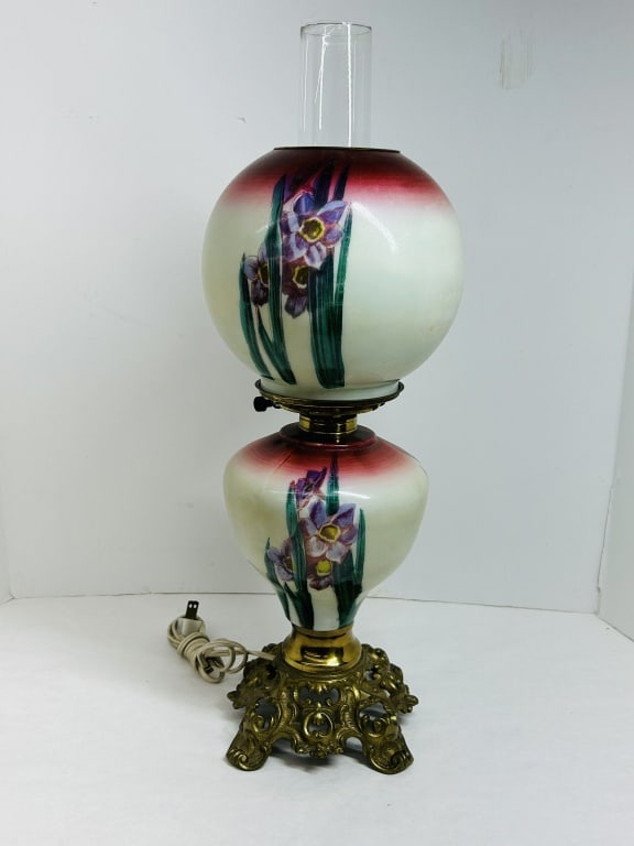 VICTORIAN GONE WITH THE WIND GLASS LAMP: Electrified parlor lamp featuring hand-painted iris motifs and red-shaded gradients on opaque cream glass components. The piece is mounted on an ornate, pierced cast metal base and includes a clear gl