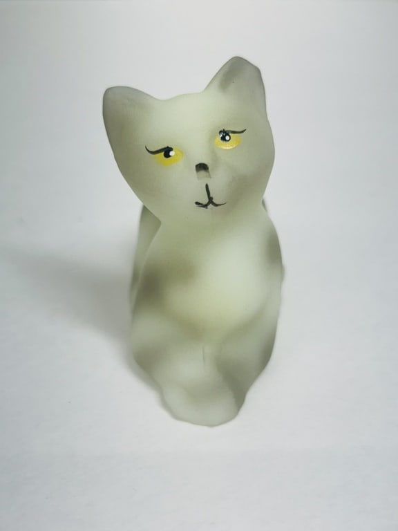 FENTON CUSTARD GLASS CAT, CIRCA 2000: Hand-painted custard satin glass cat produced by the Fenton Art Glass Company as part of a limited edition numbered 143/200. This piece is signed by artist D. Cutshaw and retains its original factory 