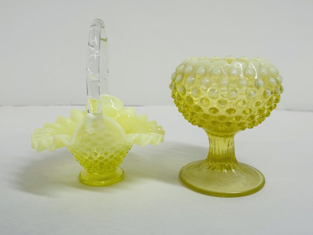 ATTRIBUTED FENTON URANIUM GLASS PAIR: A pair of yellow uranium glass vessels in the hobnail pattern featuring opalescent crimped rims, attributed to the Fenton Art Glass Company. The pair includes a basket with an applied clear handle and