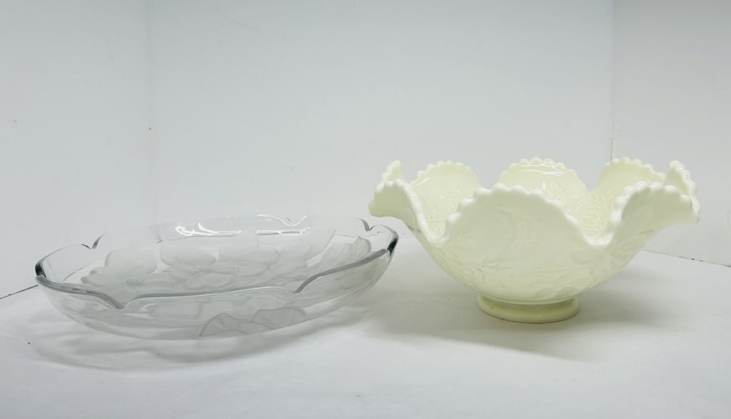 GLOWS! TWO VINTAGE FENTON STYLE GLASS PIECES: A clear glass plate with frosted dogwood blossoms and a ruffled custard glass bowl with fruit relief decoration. Both items are attributed to the Fenton Art Glass Company based on pattern and form.