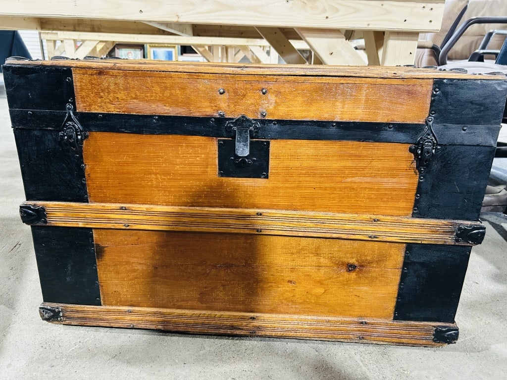 H. COHEN WOOD STEAMER TRUNK, C. 1900: Antique wooden flat-top trunk reinforced with black metal strapping and featuring a merchant label for H. Cohen of Salem, Ohio. The paper-lined interior contains an architectural cardstock model and s