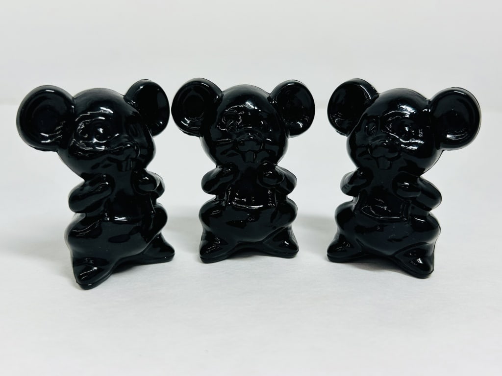 BOYD EBONY WILLIE THE MOUSE, 1978-1983: A trio of Boyd's Crystal Art Glass Willie the Mouse figurines in opaque ebony glass. Each figure displays the embossed B in a diamond trademark on the reverse.Height: 2.5 inches.