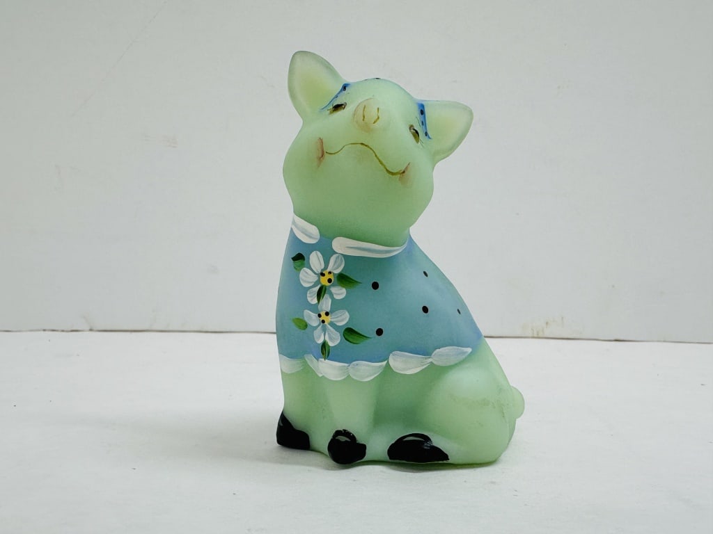 FENTON SEA MIST, FARLEY PIG FIGURINE: Seated pig figurine in Sea Mist green satin glass produced by Fenton Art Glass Company. The hand-painted piece is signed by decorator Ann Farley and bears a raised factory mark on the underside.