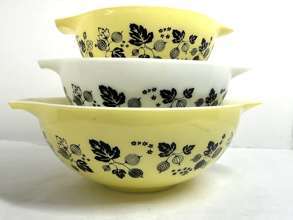PYREX GOOSEBERRY CINDERELLA GLASS BOWLS, 1960: A trio of vintage Pyrex nesting mixing bowls in the Gooseberry pattern, manufactured from opal glass between 1957 and 1966. Each bowl features signature Cinderella spout handles and embossed manufactu