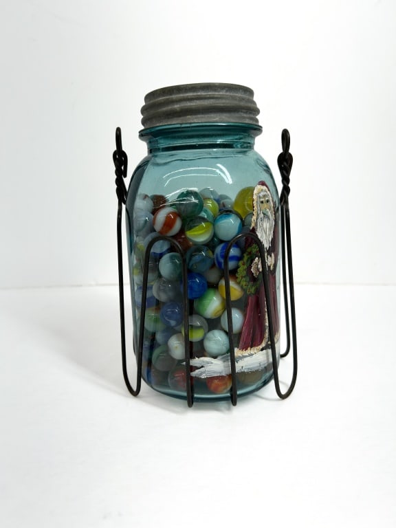 BALL GLASS JAR AND MARBLES, 1920: Vintage aqua glass jar produced by Ball featuring an embossed Perfect Mason logo and hand-painted holiday decoration. The lot includes a wire carrier and an assortment of glass marbles, including uran