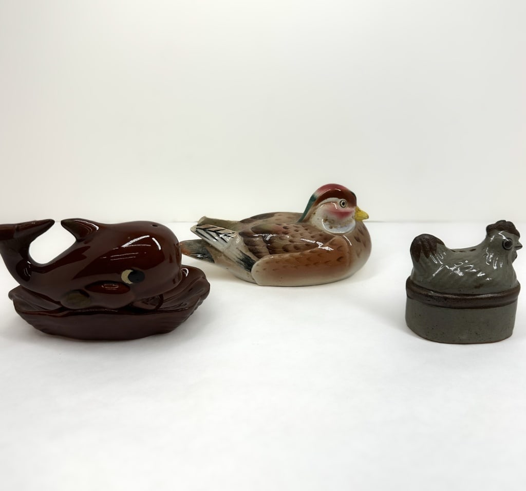 OTAGIRI CERAMIC ANIMAL TRIO, 1980S: A collection of three Otagiri glazed ceramic animal figurines including a whale on a scalloped base, a mandarin duck, and a quail. The whale and quail function as salt and pepper shakers.