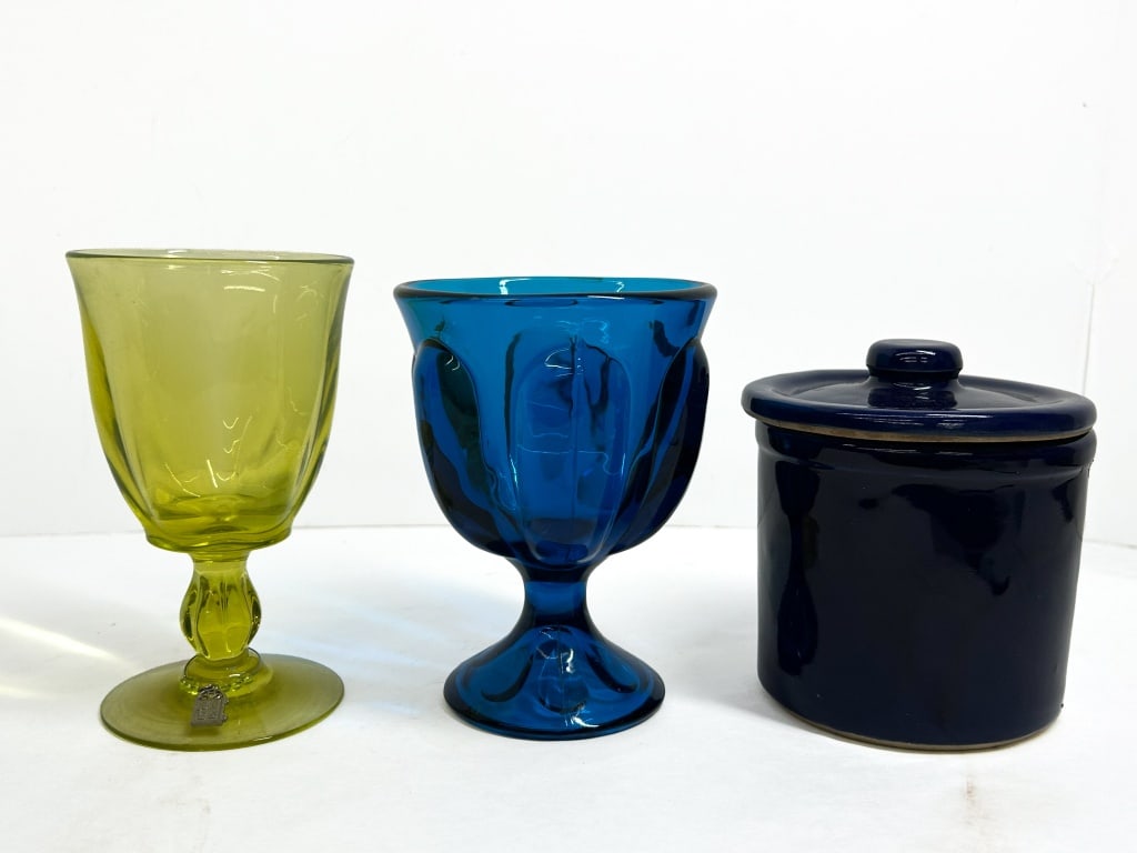 VINTAGE GLASS AND CERAMIC TRIO, 1970S: Noritake Provincial glass goblet and coordinating vessels. This lot includes a cobalt blue Noritake Provincial goblet, an avocado green pressed glass goblet, and a cobalt blue glazed ceramic jar with 