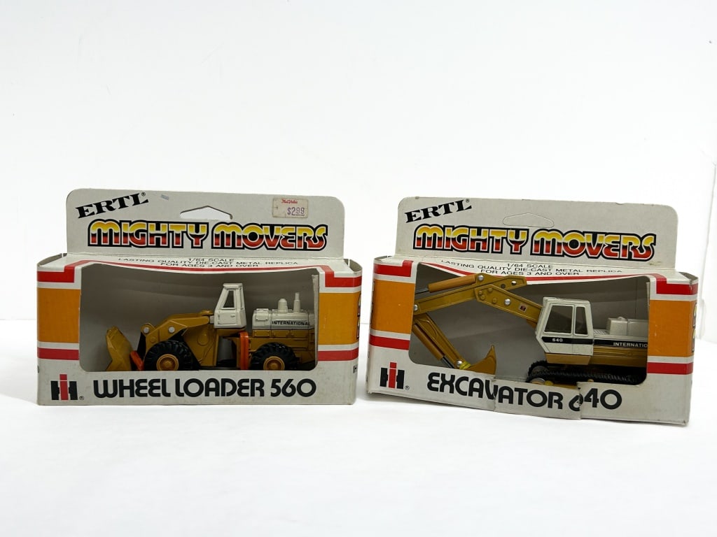 ERTL IH DIE-CAST VEHICLES 1980S: A pair of 1/64 scale die-cast metal replicas from the Mighty Movers series produced by ERTL for International Harvester. The set includes a Wheel Loader 560 and an Excavator 640, both featuring functi