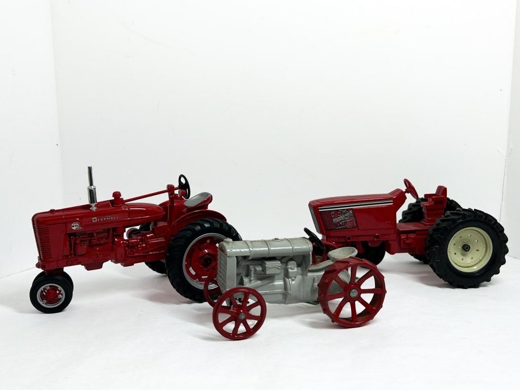 ERTL THREE DIE-CAST TRACTORS 2002: Trio of 1/16 scale die-cast farm tractors produced by ERTL, including a McCormick Farmall Super M-TA Centennial model, an International Harvester wide-front tractor, and a Fordson model. The pieces ex