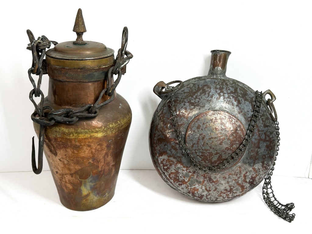 PERSIAN COPPER AND IRON VESSELS, 19TH CENTURY: Two 19th-century hand-hammered copper vessels including a lidded storage jar and a circular pilgrim flask. Each piece is fitted with original wrought iron hardware and shows evidence of artisanal cons