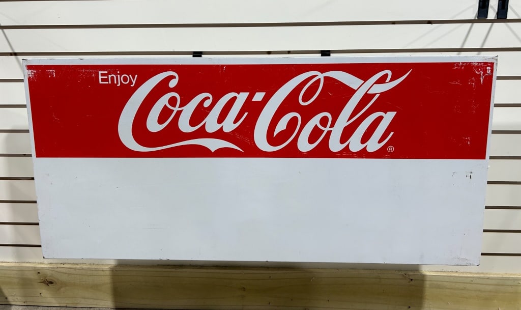 COCA-COLA METAL PRIVILEGE PANEL, 1970S: Coca-Cola metal advertising sign featuring the Enjoy Coca-Cola logo and dynamic ribbon device above a large white privilege panel. The piece is constructed from sheet metal with folded flange edges fo