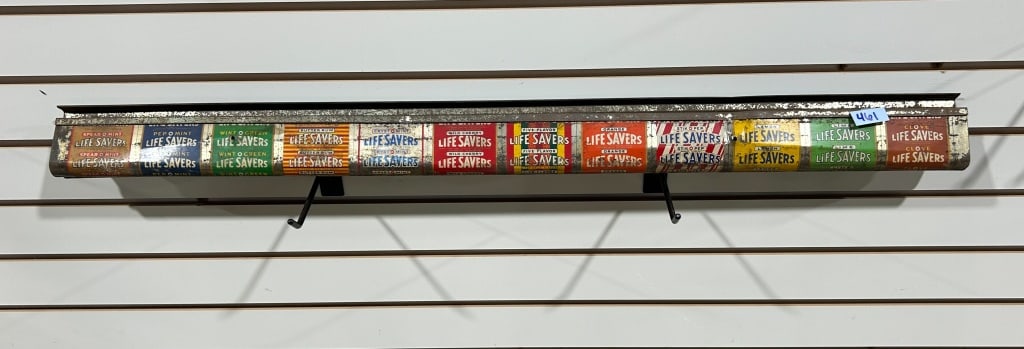 LIFE SAVERS TIN DISPLAY RACK, 1950S: Vintage lithographed tin advertising display rack manufactured by the Life Savers Corporation of Port Chester, New York. The panel features graphics for twelve candy flavors including discontinued var