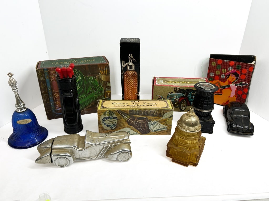 AVON GLASS FRAGRANCE DECANTERS, 1960s-1970s: An assortment of vintage Avon figural glass decanters for cologne and aftershave, including automotive, architectural, and novelty forms in various colors and finishes. Several items include original 