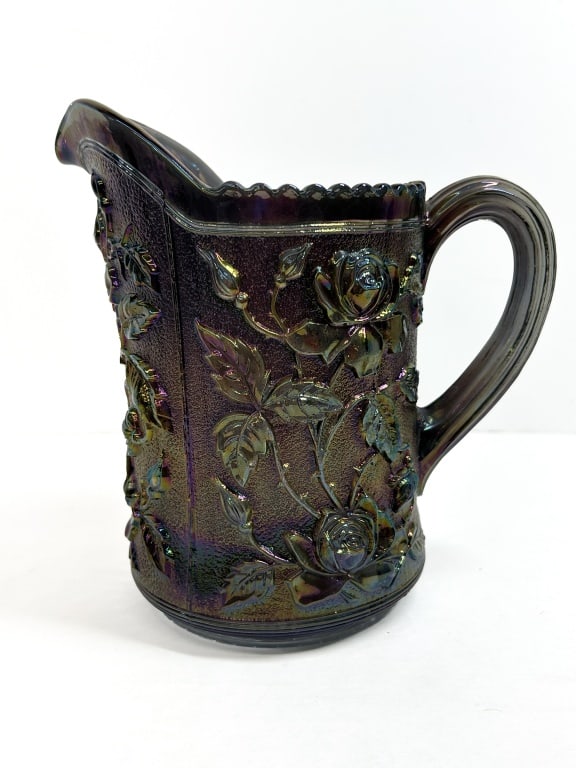 IMPERIAL AMETHYST LUSTRE ROSE PITCHER, 1950S: Imperial Glass Company amethyst carnival glass water pitcher in the Lustre Rose pattern. The vessel features relief-molded floral decoration against a stippled ground and bears a molded IG trademark o