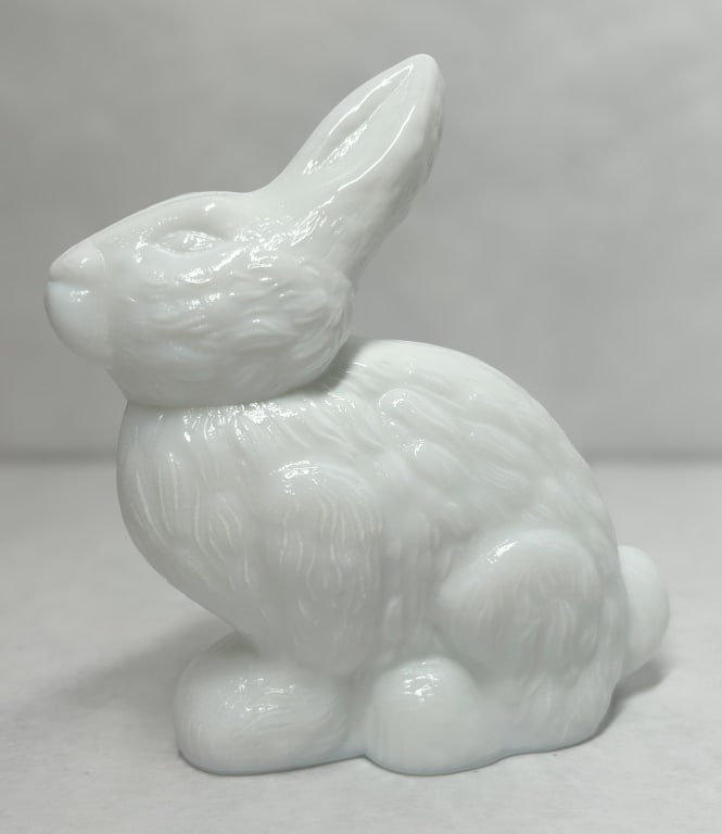 MOSSER MILK GLASS STANDING BUNNY, VINTAGE: A Mosser Glass standing bunny figurine crafted from opaque white milk glass. The piece features a pressed fur texture and a fire-polished finish. Height: 5.5 inches.