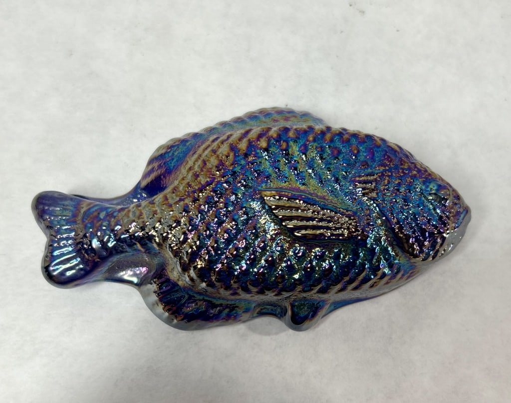 IRIDESCENT GLASS SUNFISH FIGURINE: A molded glass figurine depicting a sunfish with a heavy metallic iridescent finish. The piece features detailed scales and fins with a flat, unmarked base.