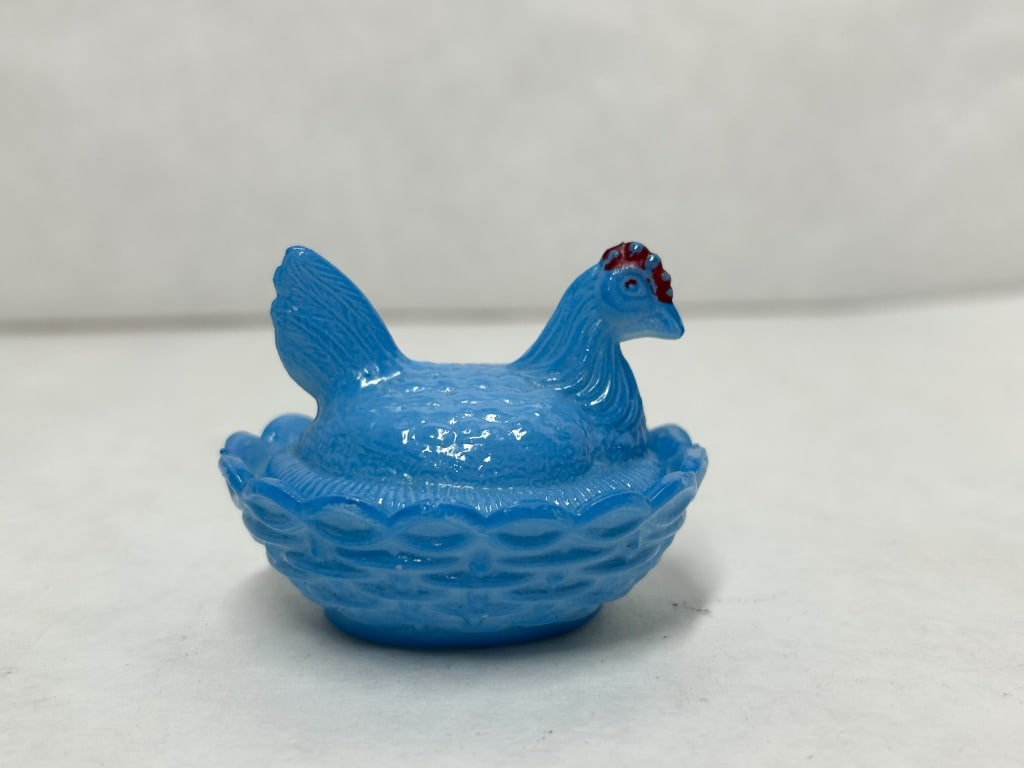 BLUE MILK GLASS HEN ON NEST: A miniature two-piece covered dish in opaque blue milk glass depicting a nesting hen. This item features molded feather and basketweave textures and red cold paint on the comb. No maker marks or label
