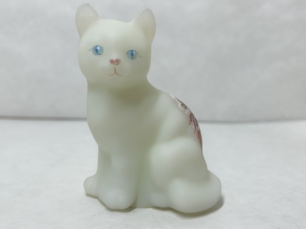 FENTON SATIN GLASS CAT FIGURINE: Hand-painted white satin glass cat figurine produced by Fenton Art Glass. The underside bears an original silver and black foil label reading Handmade in USA and FENTON around a stylized F, alongside 
