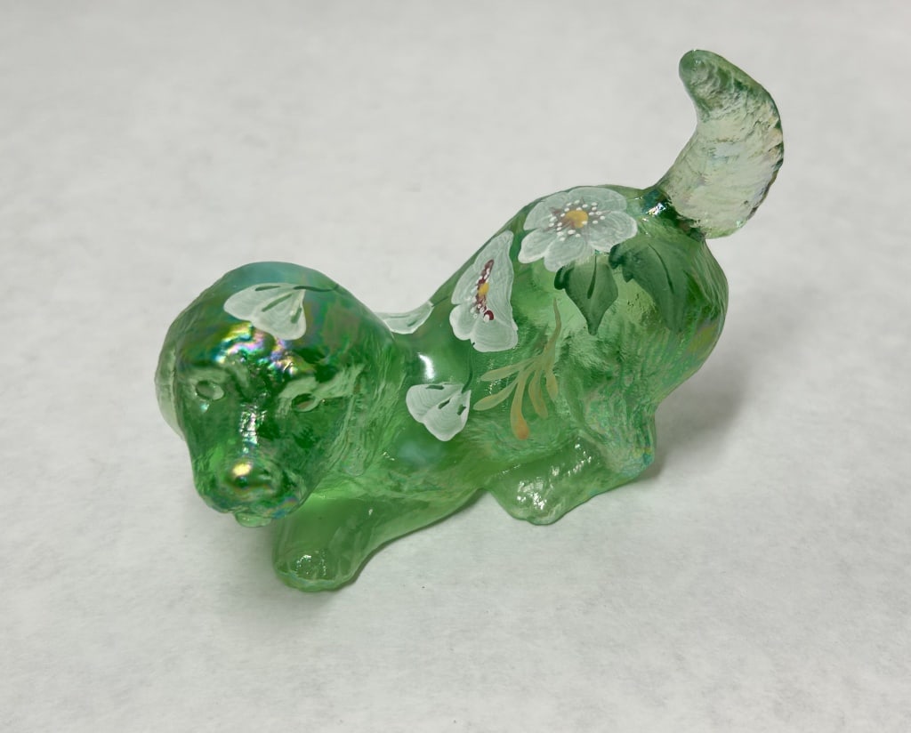 FENTON IRIDESCENT GREEN GLASS DOG, 2000: Fenton Art Glass 95th Anniversary figurine of a puppy in a play bow pose, executed in iridescent green glass with hand-painted floral motifs. The underside displays a molded circular mark containing 9