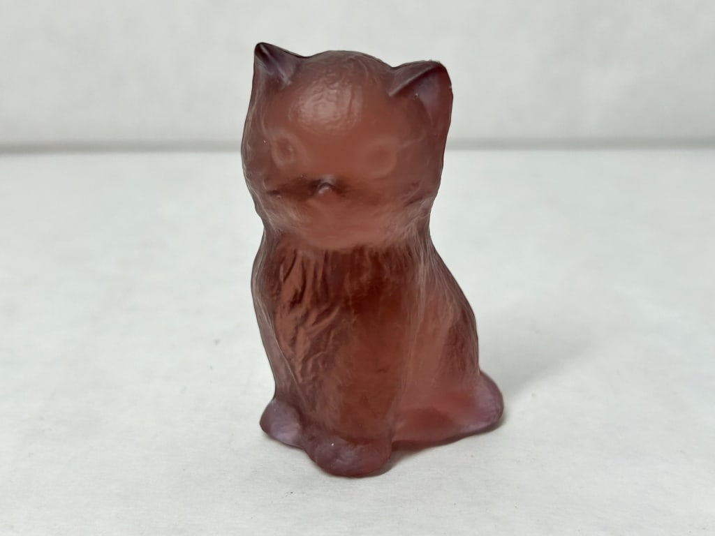 BOYD GLASS BURGUNDY SATIN KITTEN, 1978-1983: Seated kitten figurine produced by Boyd's Crystal Art Glass. An embossed diamond mark containing a capital letter B is visible on the lower rear of the body.