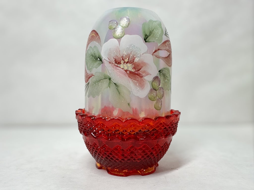 FENTON RUBY GLASS FAIRY LAMP, 1970S: Two-piece iridized and ruby glass fairy lamp produced by Fenton Art Glass Company featuring hand-painted floral decoration signed Hand Painted by G. Lowe. The shade bears a manufacturer label and an e