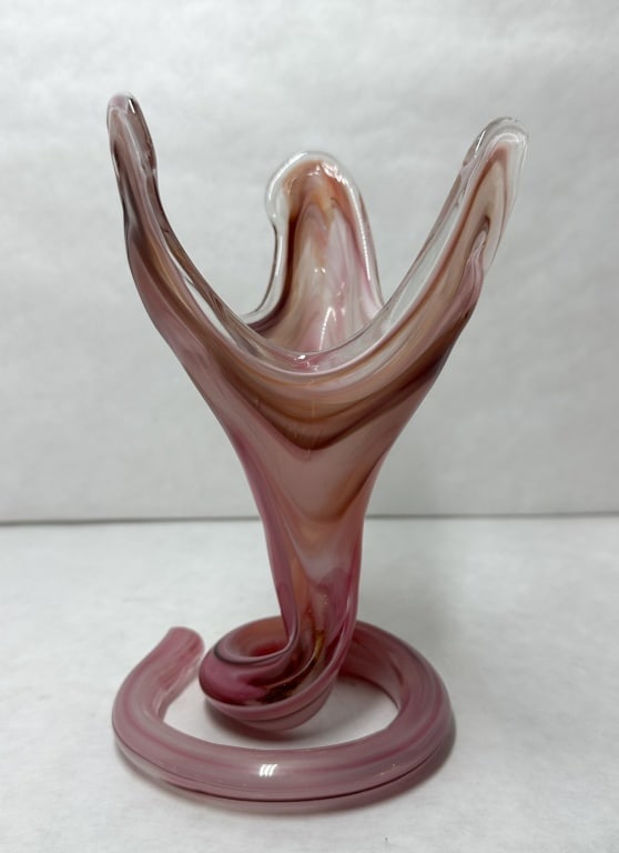 MCM SWIRLED ART GLASS TRUMPET VASE: A hand-blown glass vase featuring a tri-lobed flared rim and a coiled spiral base, constructed with swirled pink, burgundy, and white glass encased in a clear layer. The underside of the coiled base i