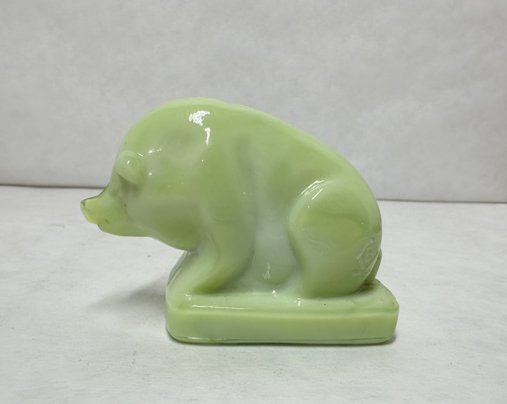 BOYD JADEITE GLASS SUEE PIG: Seated pig figurine produced by Boyd Crystal Art Glass in marbled jadeite slag glass. An impressed capital letter B within a diamond is located on the rear left haunch.