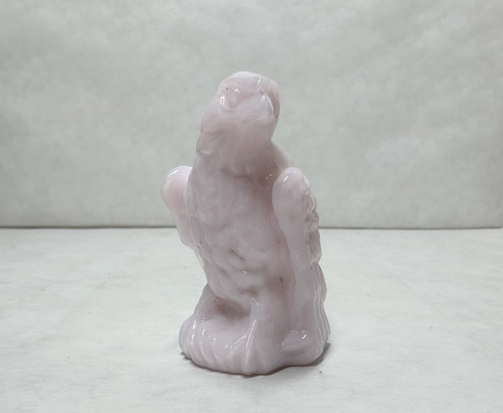 BOYD BERNIE THE EAGLE PINK SLAG GLASS EAGLE: Molded eagle figurine composed of opaque pink slag glass. A molded mark consisting of a capital letter B within a diamond shape is located on the lower reverse tail feathers.