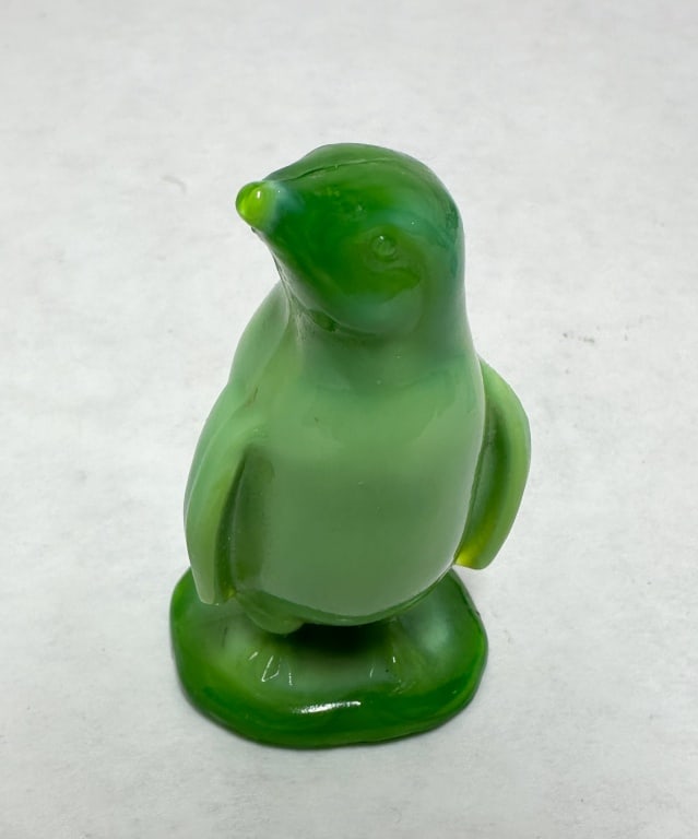 BOYD GREEN ARTIE THE PENGUIN: Vintage pressed green slag glass figurine of a penguin standing on an integral oval base. The reverse features an embossed B in a diamond mark with a single horizontal bar, identifying the piece as