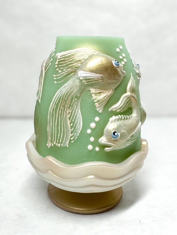RARE FENTON GREEN GLASS FAIRY LAMP SPINDLER 2/5: A two-piece satin lime green glass fairy lamp produced by Fenton Art Glass featuring a high-relief aquatic scene with long-finned fish and bubbles. The interior rim of the shade bears a handwritten go