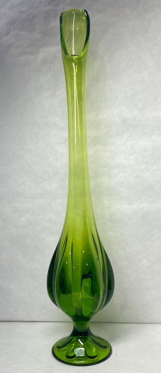 KANAWHA GREEN SWUNG GLASS VASE, 1960S: Hand-blown swung glass pedestal vase produced by Kanawha Glass Company, featuring a six-petal lobed foot and gradated green colorway. A square silver foil label is applied to the foot with the charact