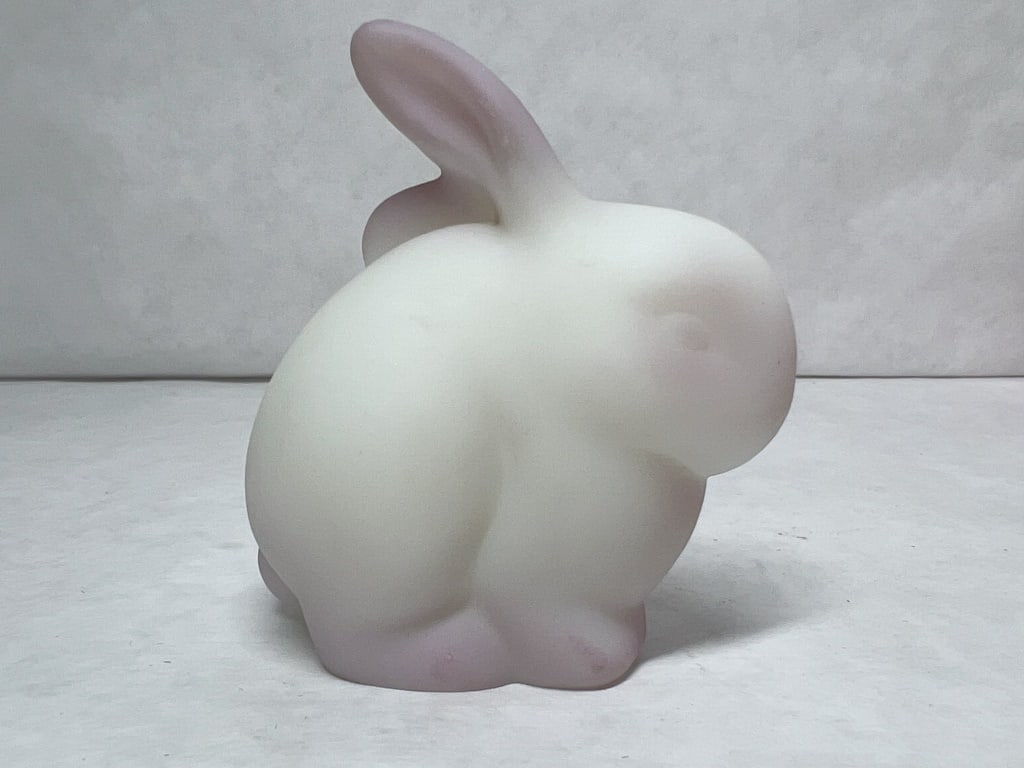 FENTON SIGNED FROSTED SATIN GLASS RABBIT: White frosted satin glass rabbit figurine featuring hand-painted pink airbrushed accents on the ears, feet, and tail. The underside of the base bears a handwritten signature in black ink reading Becky