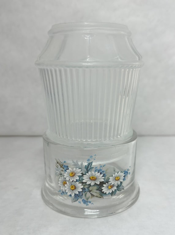 MOSSER X ROSSO VINTAGE FAIRY LAMP: Clear pressed glass fairy lamp consisting of a vertically ribbed shade and a cylindrical base. The base features a multi-colored floral decal depicting daisies and forget-me-nots, and no maker marks a