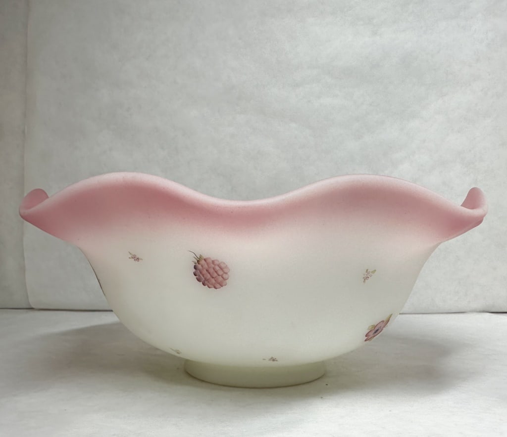 FENTON HAND-PAINTED PINK SATIN GLASS BOWL, 1970S: Hand-painted satin glass bowl featuring a heat-sensitive pink-to-white color transition and a crimped, ruffled rim. The exterior is decorated with enameled floral and berry motifs.
