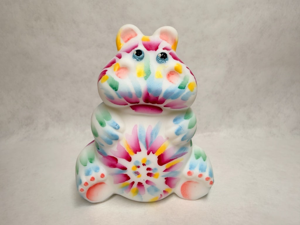 JK SPINDLER FENTON TIE DIE HIPPO 44/100: Hand-painted produced by Julie K. Spindler depicting a whimsical rotund animal. A hand-signed inscription in gold ink is visible on the base reading 2023, JKSpindler, and 44/100.