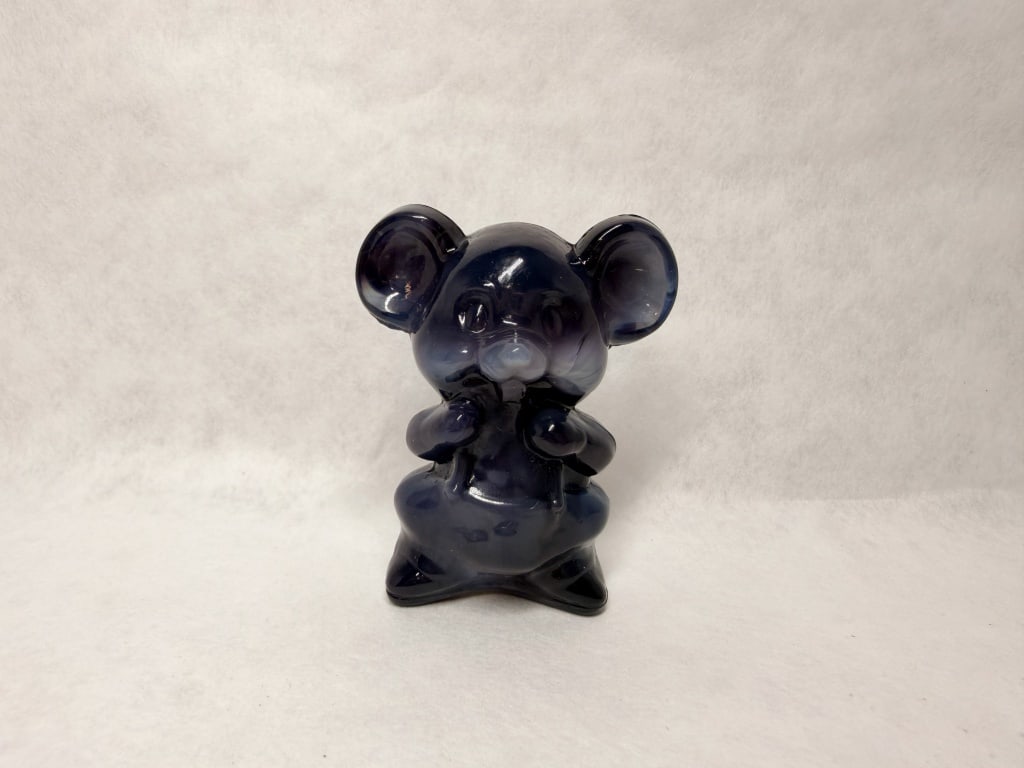 BOYD HEATHER GRAY GLASS MOUSE, 1988-1993: Seated mouse figurine in cobalt blue and white swirled slag glass produced by Boyd?s Crystal Art Glass. An embossed diamond mark containing a capital letter B with two horizontal lines is located on t