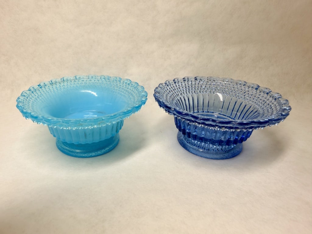 BOYD BLUE PRESSED GLASS BOWLS, 1980S: A pair of blue pressed glass bowls produced by Boyd's Crystal Art Glass. Each piece features a molded monogram consisting of the letter B within a diamond to the center interior.