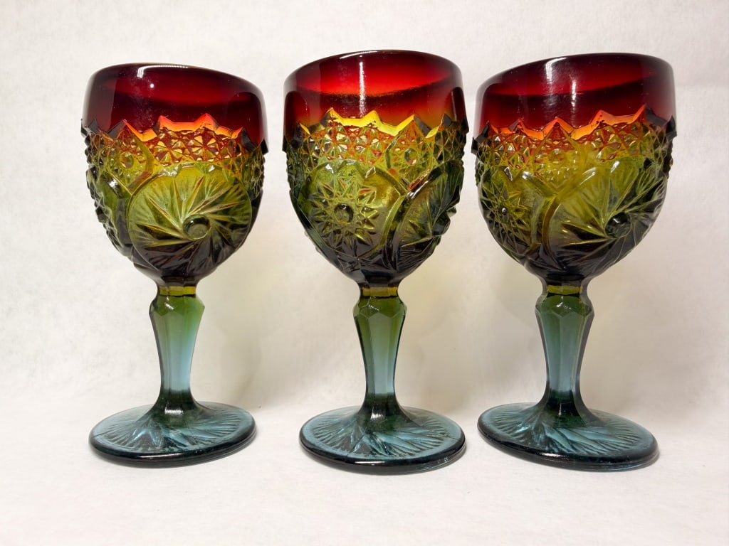 BOYD'S CRYSTAL RAINBOW GLASS GOBLETS, 1980S: A set of three multi-colored pressed glass goblets by Boyd's Crystal Art Glass featuring a Pinwheel and Star pattern. Each goblet bowl features a molded mark consisting of a capital letter B inside a