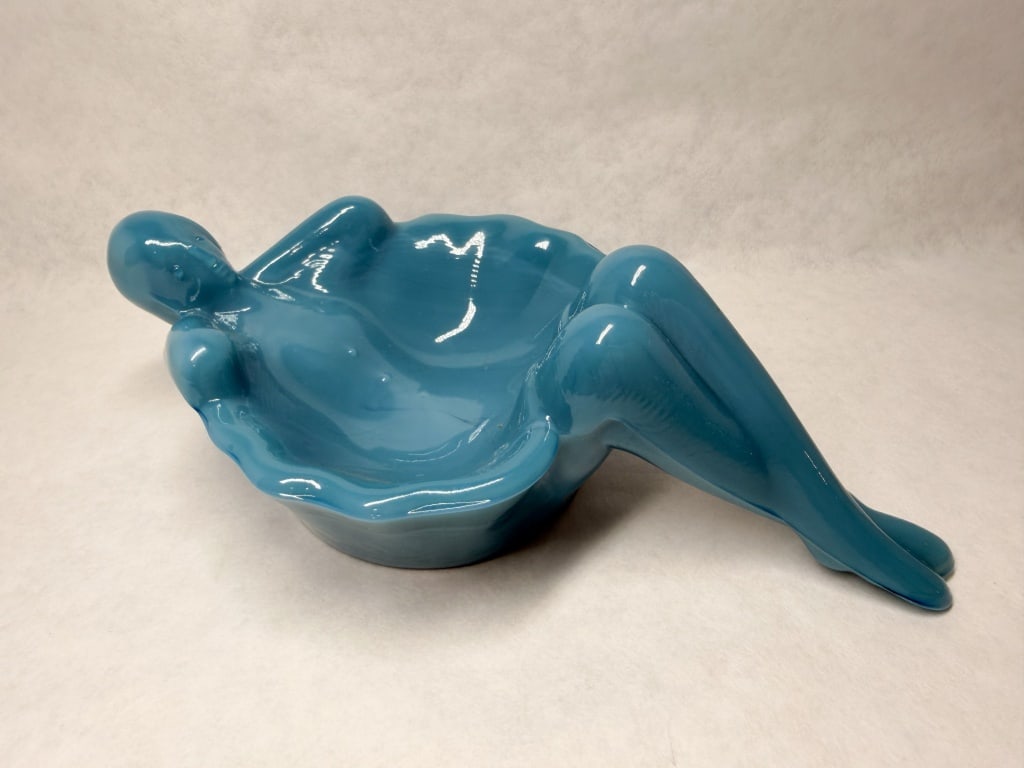 MOSSER TEAL BATHING BEAUTY SOAP DISH: A contemporary pressed glass soap dish in the form of a reclining female figure. The piece features a high-gloss teal finish and stylized anatomical details.