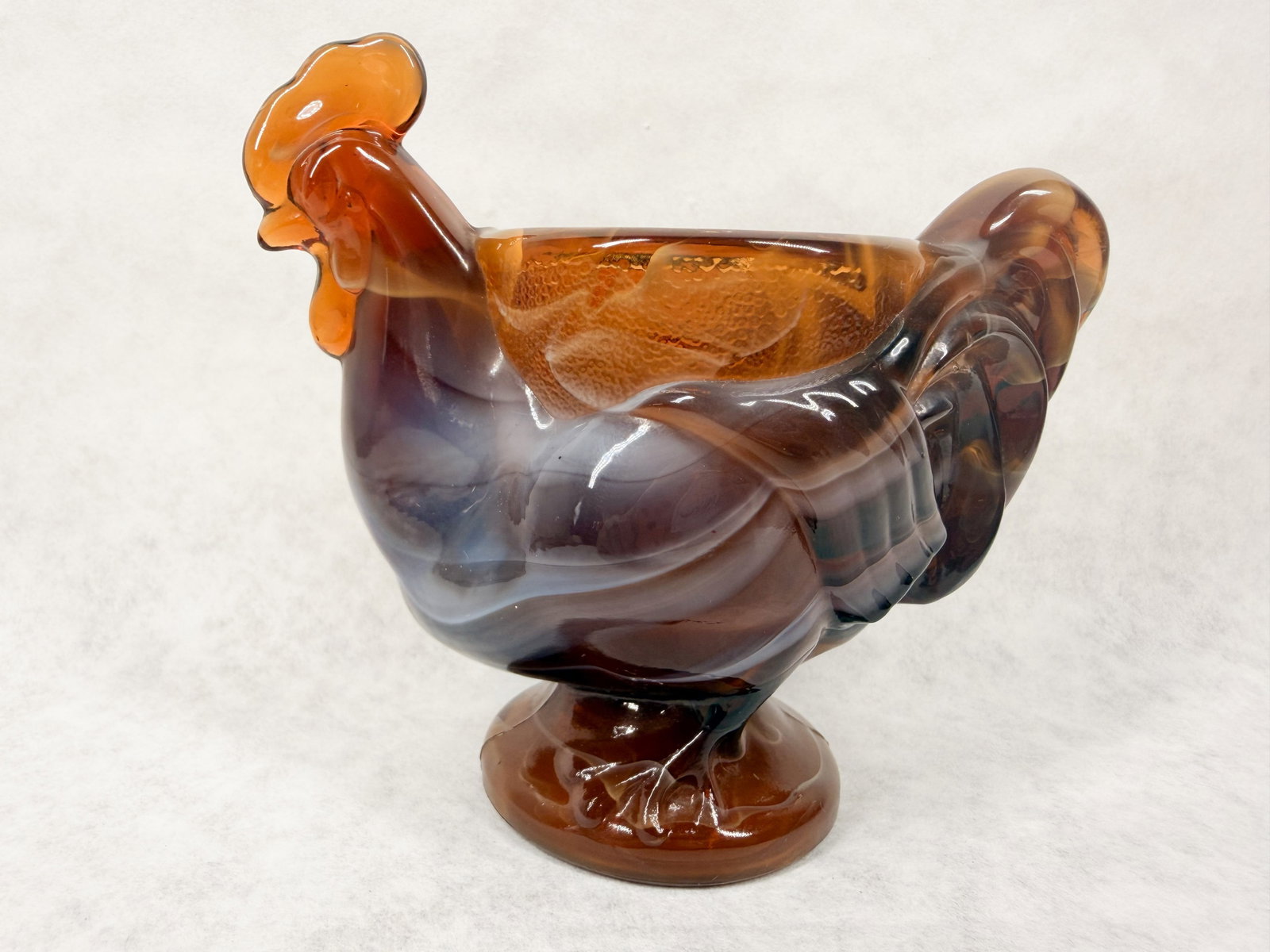IMPERIAL GLASS CARAMEL SLAG TOOTHPICK HOLDER: A standing rooster cup in chocolate slag glass produced by the Imperial Glass Corporation. The underside of the footed base bears an embossed monogram consisting of a stylized capital I superimposed
