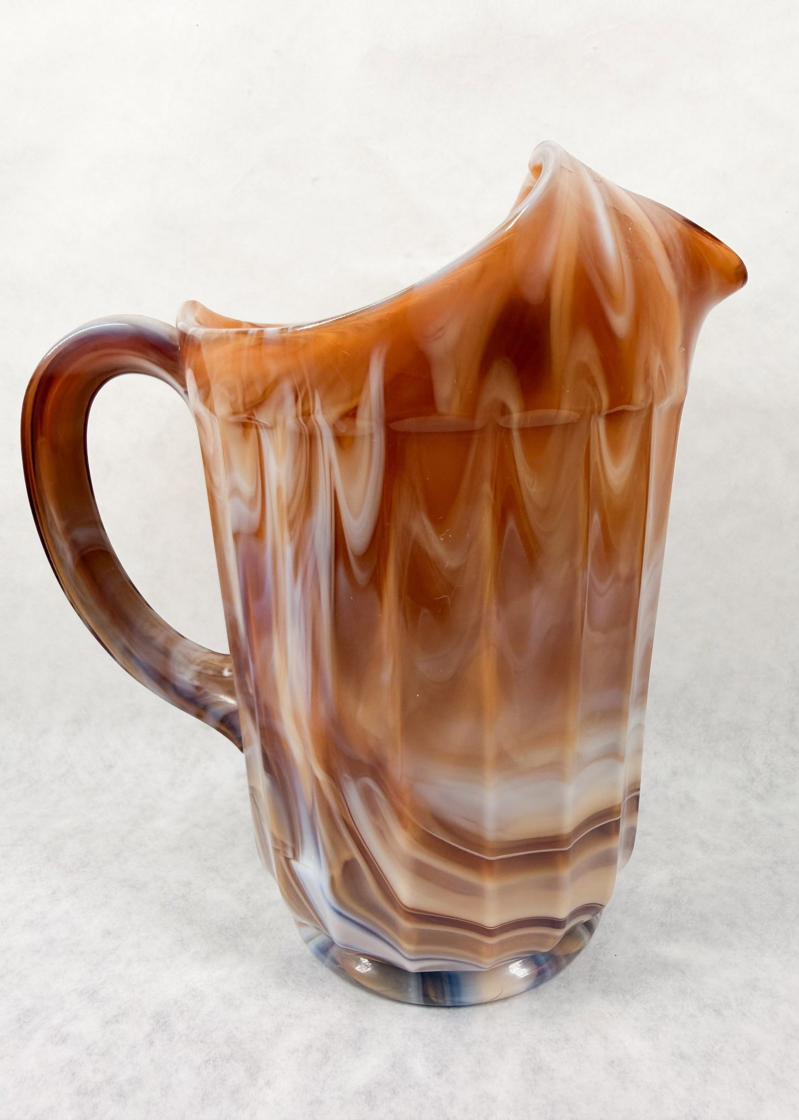 IMPERIAL CARAMEL SLAG PITCHER, VINTAGE: A vintage fluted slag glass pitcher produced by the Imperial Glass Corporation in the caramel colorway. The interior rim bears an original blue and silver foil label reading Imperial Glass Co.