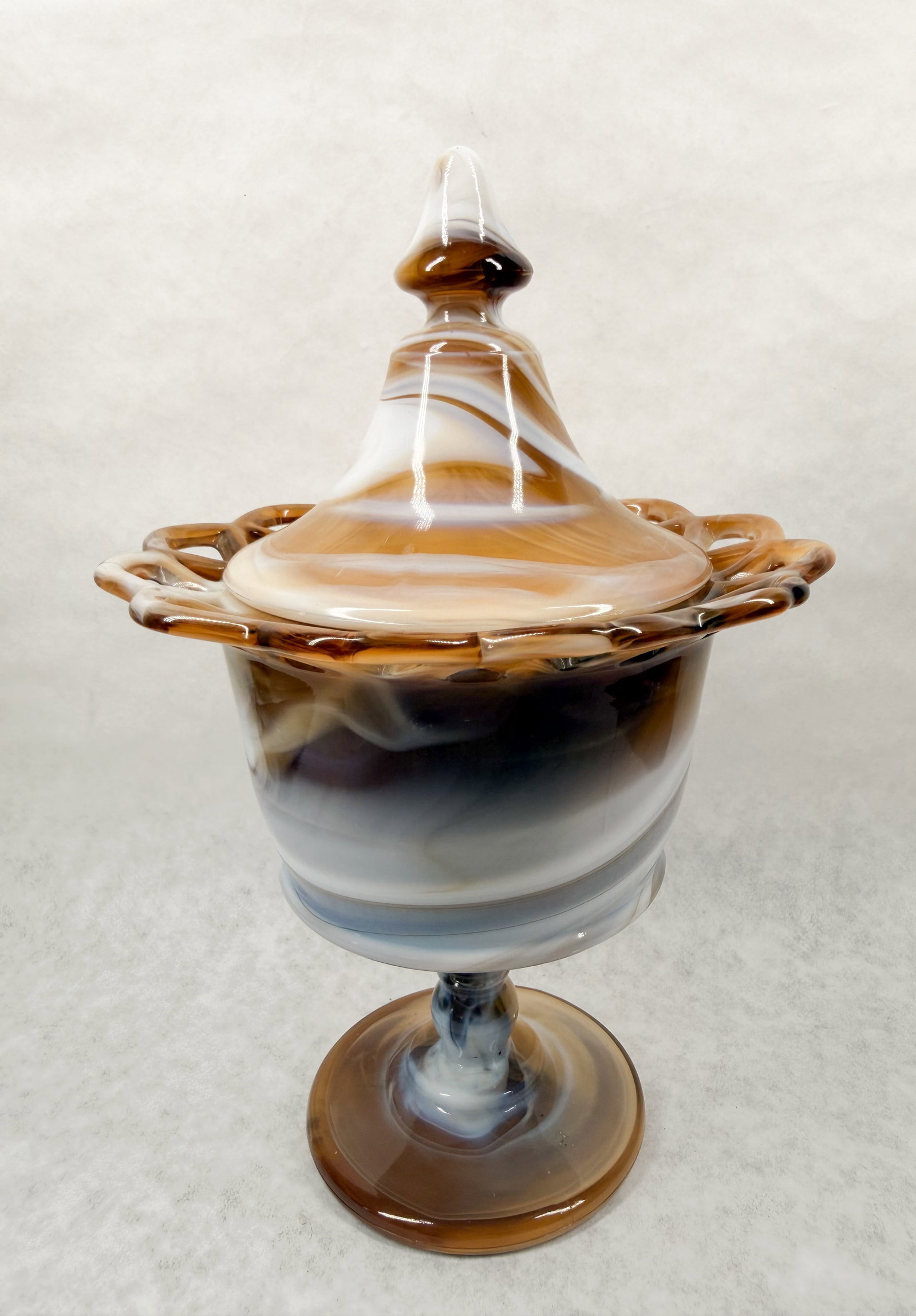 IMPERIAL CARAMEL SLAG LIDDED COMPOTE: The lot consists of a footed compote with a lattice rim and matching lid.