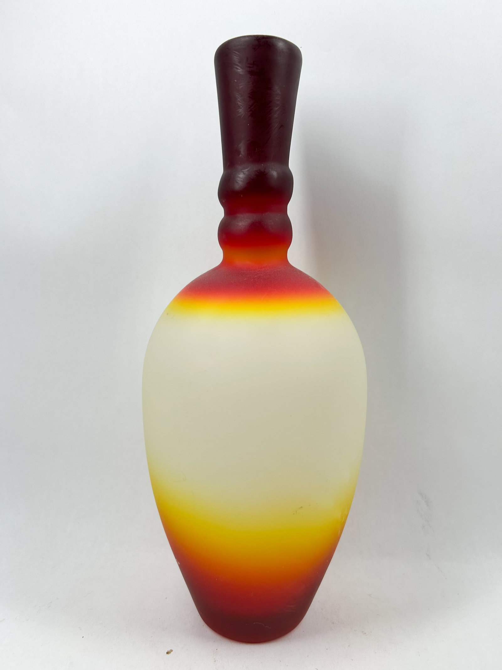 IMPERIAL ANNULATED PEACHBLOW SATIN GLASS VASE: A cased-glass vessel featuring a tri-color sunset gradient transitioning from ruby red to orange and yellow over an opaque white interior with a matte satin finish. The ovoid body tapers to a tall nec