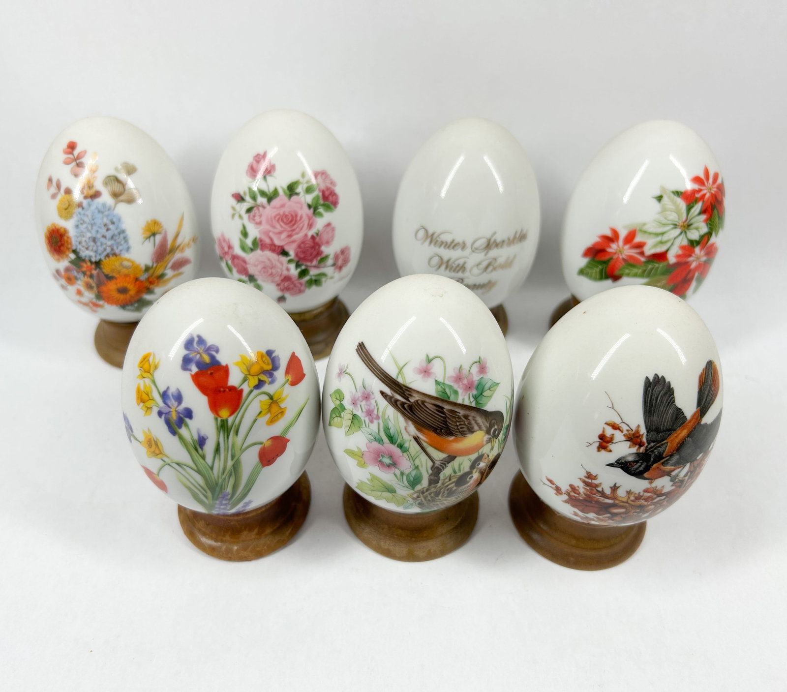 SEVEN DECORATIVE PORCELAIN EGGS AND STANDS (1 of 3)