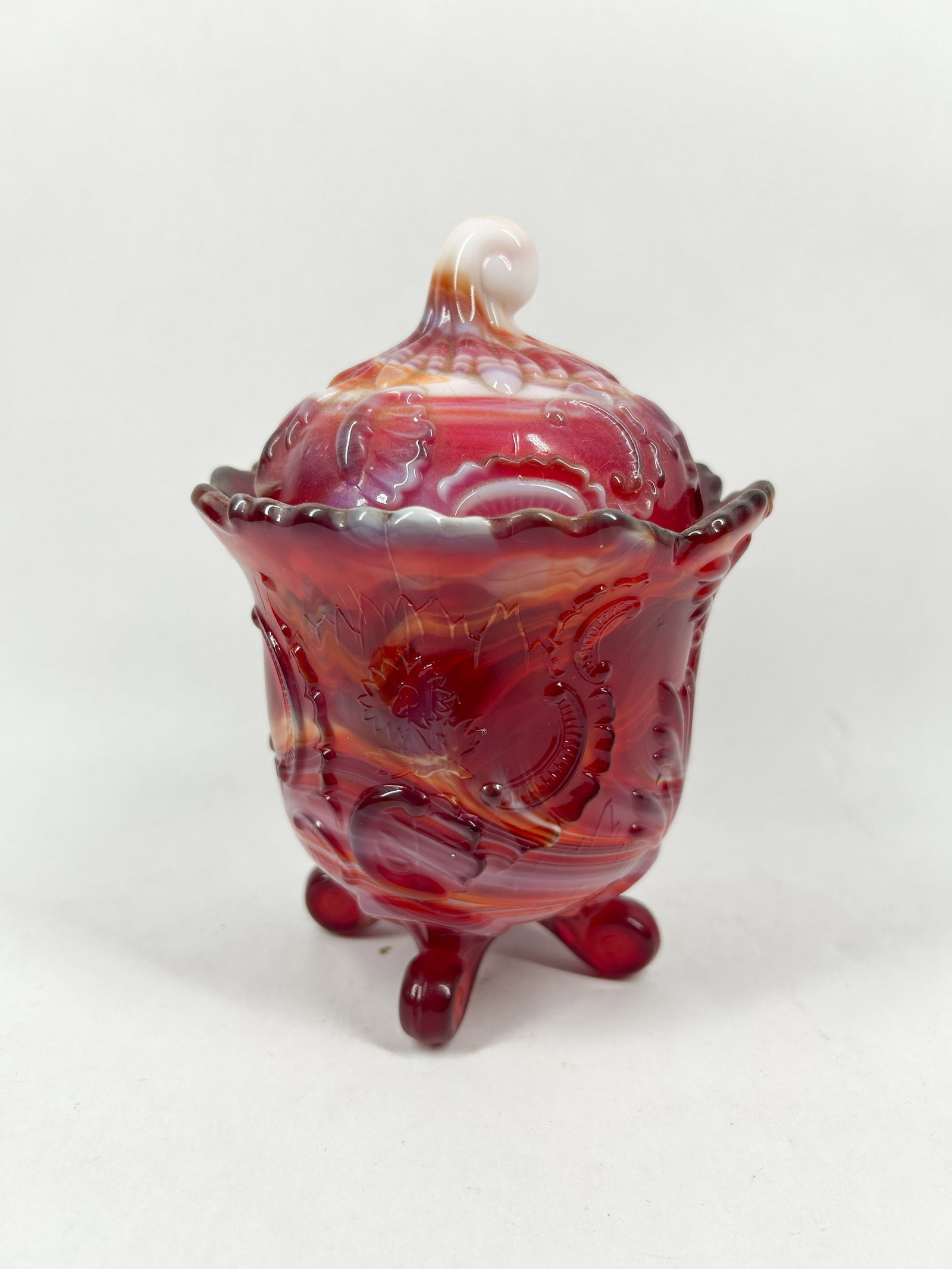 IMPERIAL RED SLAG JAR: A lidded footed bowl in red marbled slag glass