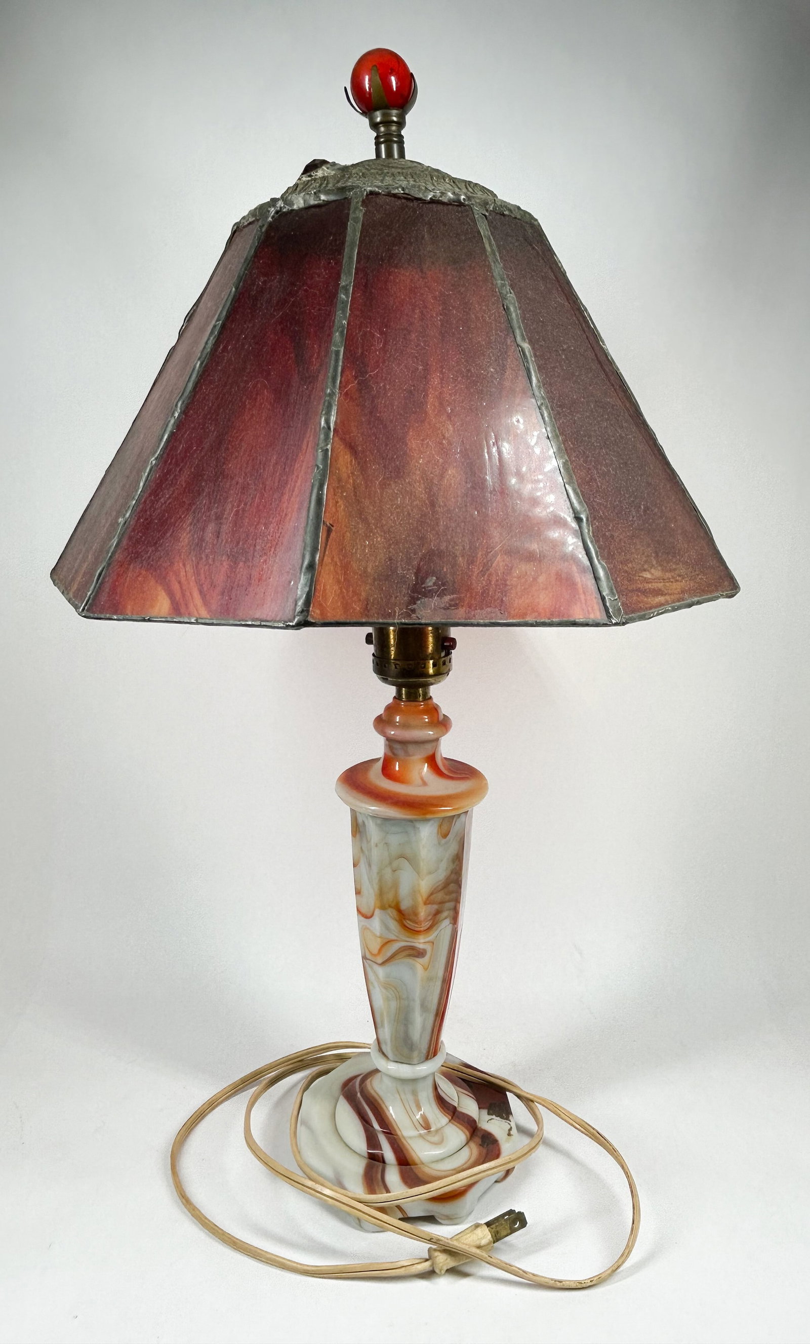 VINTAGE ORANGE SLAG GLASS TABLE LAMP: Vintage table lamp featuring matching orange and cream swirled slag glass panels in the base and octagonal shade. No maker marks, signatures, or factory stamps are visible on the glass or metal compon