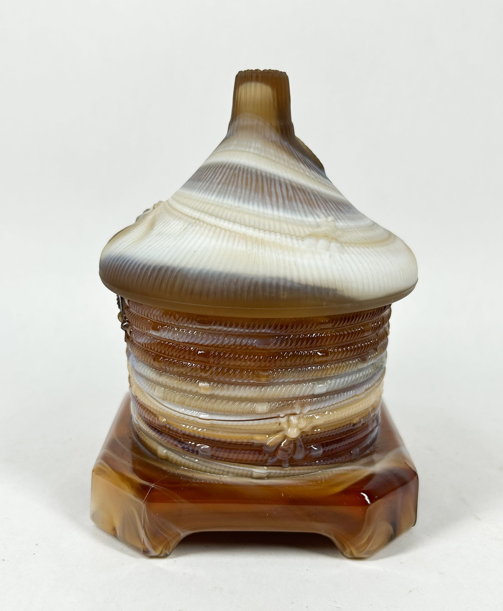 IMPERIAL SLAG GLASS BEEHIVE HONEY JAR, MID-20TH CENTURY: Lidded chocolate slag glass honey jar in a beehive form, manufactured by the Imperial Glass Company. An impressed monogram consisting of a stylized capital I superimposed on a capital G within a