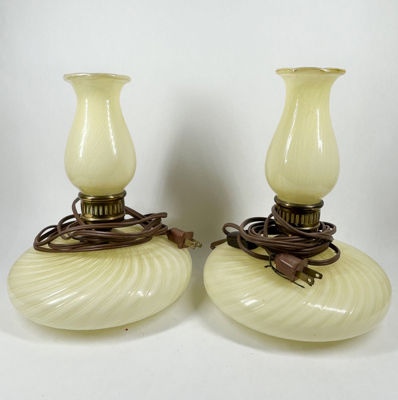 PENNSYLVANIA GLASS CUSTARD GLASS LAMPS VINTAGE: A pair of vintage table lamps by Pennsylvania Glass featuring custard glass with a spiral ribbed pattern. Each base is embossed on the underside with the words PENNSYLVANIA GLASS and HANDMADE, and one