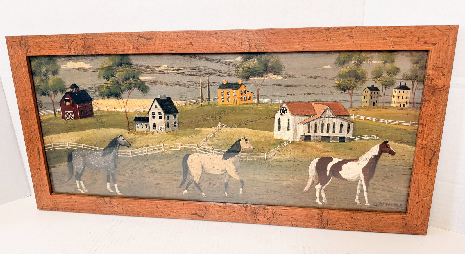CHRIS PALMER HORSES WOOD PANEL: Chris Palmer folk art scene depicting three horses in a rural landscape. Signed CHRIS PALMER at the lower right, this acrylic on wood panel retains a biographical artist label and a North American Enc